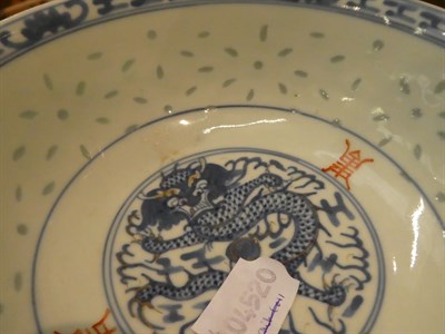 Lot 52 - A Chinese bowl painted in underglaze blue with a dragon and shou characters to the interior and...