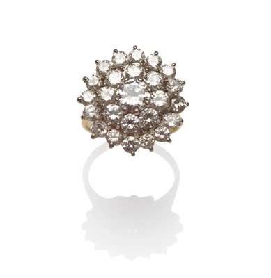 Lot 602 - A Diamond Cluster Ring, a round brilliant cut diamond within a border of eight smaller, and a...