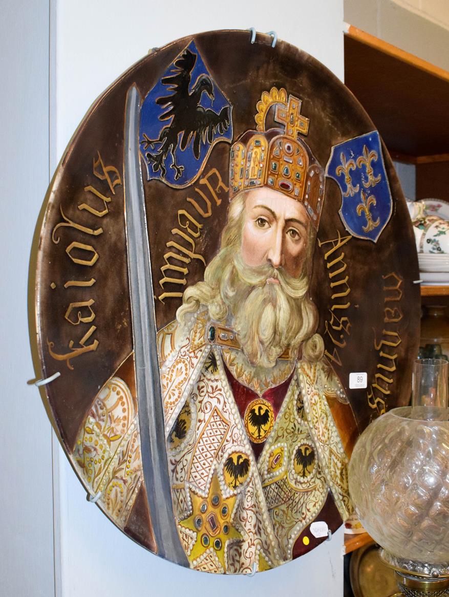 Lot 89 - A large Continental pottery plaque decorated with a central portrait of a King, thought to be...
