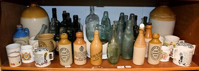 Lot 90 - A quantity of glass and stoneware bottles including advertising examples, Ross & Co. Fleet,...