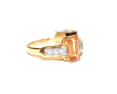 Lot 101 - A topaz and diamond ring, the emerald-cut golden topaz in a yellow four claw setting, to an...