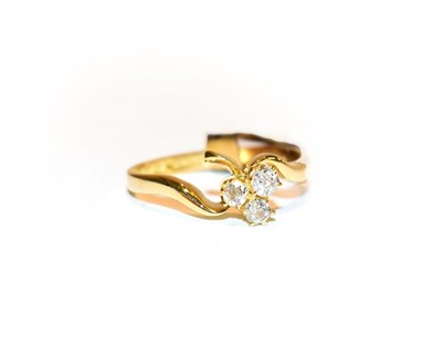 Lot 104 - An 18 carat gold diamond three stone ring, the three old cut diamonds in a clover arrangement,...