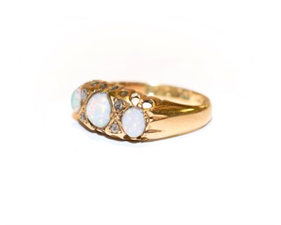 Lot 109 - An 18 carat gold opal three stone ring with rose cut diamond accents, finger size M
