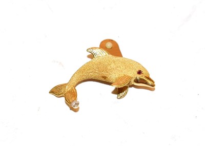 Lot 111 - A synthetic ruby and diamond dolphin brooch, the realistically modelled dolphin with a yellow...