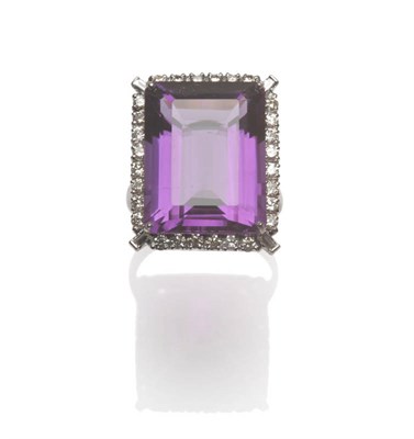 Lot 606 - An 18 Carat White Gold Amethyst and Diamond Ring, the step cut amethyst with truncated corners...