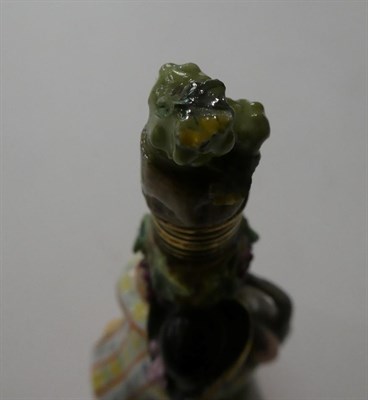 Lot 116 - A 19th century Meissen scent bottle, formed as a boy wearing a tricorn hat chasing a goat,...