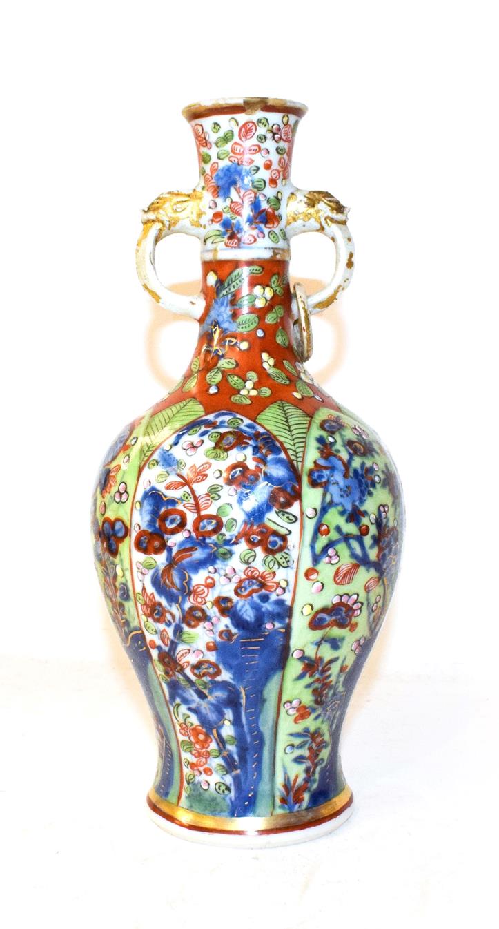 Lot 132 - An 18th century Chinese vase of baluster form and with twin loop handles moulded with masks,...