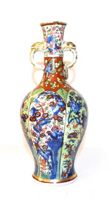 Lot 132 - An 18th century Chinese vase of baluster form and with twin loop handles moulded with masks,...