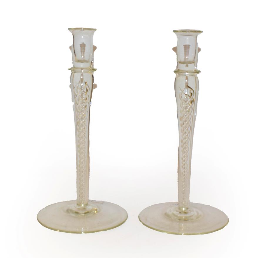 Lot 133 - A pair of glass candlesticks, with plain nozzles and raised on airtwist stems, 25.5cm (2)