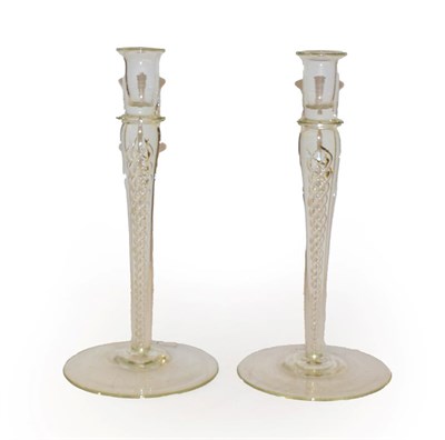 Lot 133 - A pair of glass candlesticks, with plain nozzles and raised on airtwist stems, 25.5cm (2)