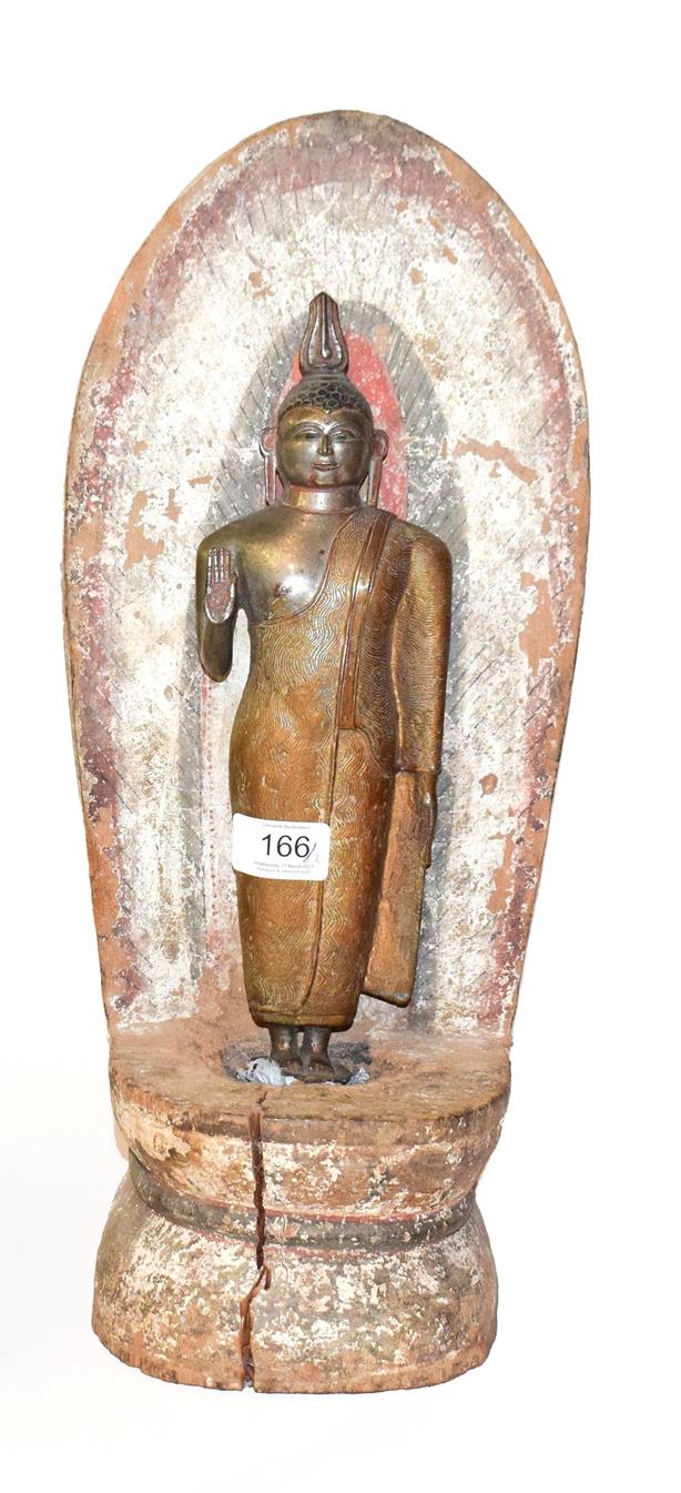 Lot 166 - A silvered and gilt-metal standing Buddha, probably 19th century, on wooden painted plinth with...