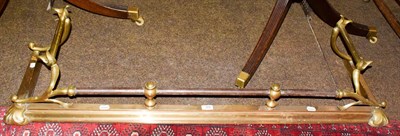 Lot 202 - An Art Nouveau brass fender, internal measurement 122cm by 30cm, outer 133cm by 37cm