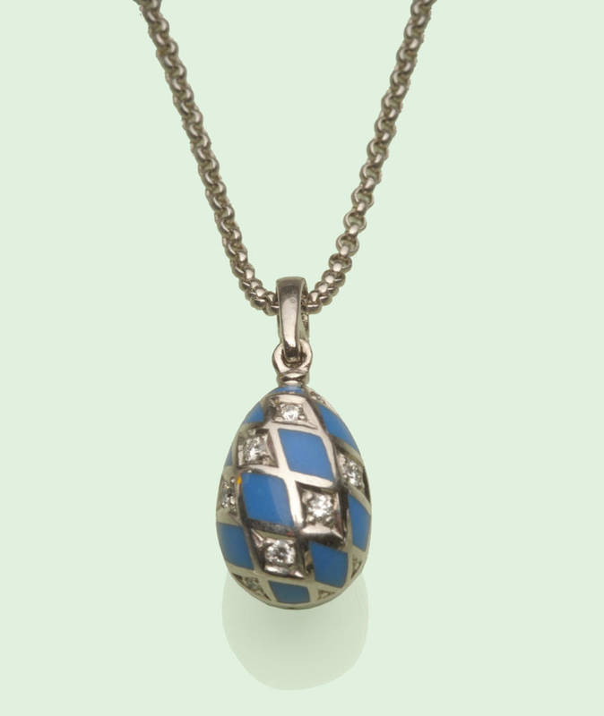 Lot 618 - A Modern 18 Carat White Gold Faberge Egg Pendant and Chain, the egg enamelled in light blue diamond