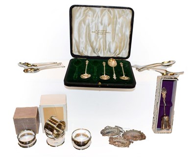 Lot 235 - A collection of assorted silver, including four various napkin-rings, three modern decanter...
