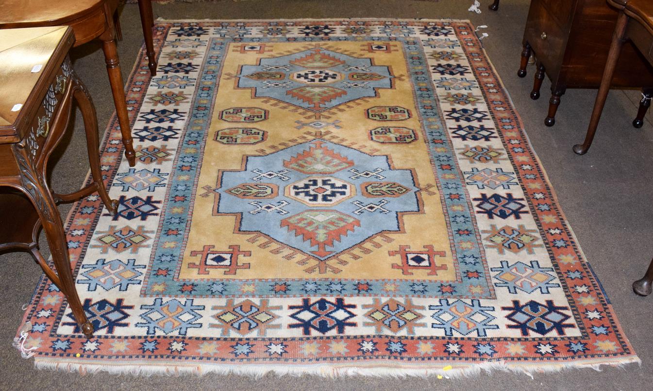 Lot 1078 - A polychrome carpet with a central blue ground medallion, 242cm by 184cm