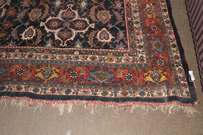 Lot 1079 - A Bidjar carpet, the indigo field with columns of polychrome florwerheads enclosed by madder...