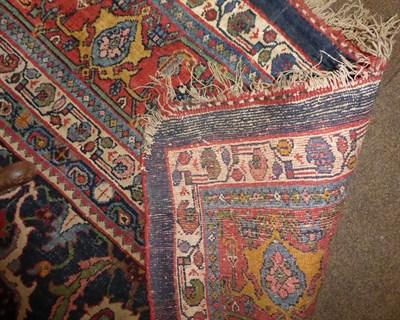 Lot 1079 - A Bidjar carpet, the indigo field with columns of polychrome florwerheads enclosed by madder...
