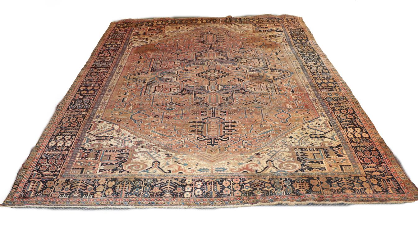 Lot 1085 - Heriz carpet, Iranian Azerbaijan circa 1920. The faded madder field with typical indigo...
