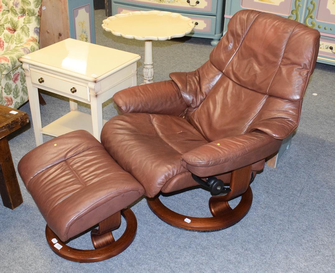 Lot 1094 - An Ekornes Stressless brown leather armchair and footstool