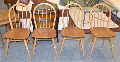 Lot 1109 - A set of four light elm hoop back dining chairs