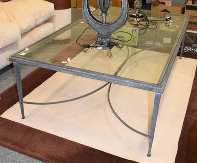 Lot 1111 - A wrought metal and glass coffee table, 150cm by 90cm
