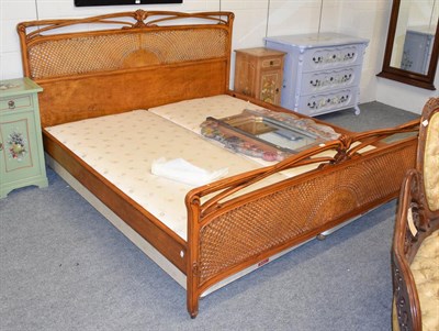 Lot 1122 - A French style caned hardwood bed, super king sized 192cm by 212cm, 110cm high
