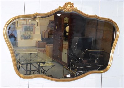 Lot 1125 - A modern gilt framed mirror with shell surmount, 120cm by 79cm