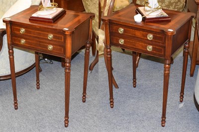 Lot 1137 - A pair of reproduction crossbanded mahogany bedside tables, each fitted with two drawers on...