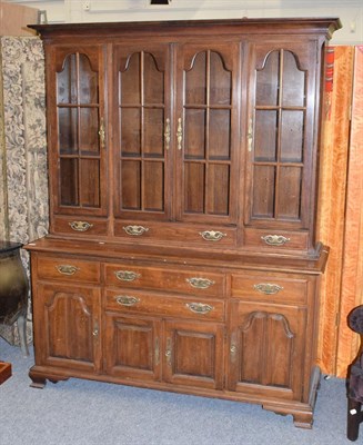 Lot 1147 - A glazed bookcase cabinet, 158cm by 52cm by 197cm