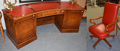 Lot 1153 - A modern red leather inset bur yew kneehole desk, the moulded curved top over a central drawer...
