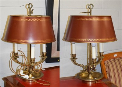 Lot 1154 - A pair of brass three branch rise and fall table lamps with Toleware shades, 62cm high