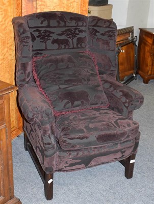 Lot 1163 - A Websters Interiors wingback chair in animal design upholstery, 82cm by 77cm, 109cm high