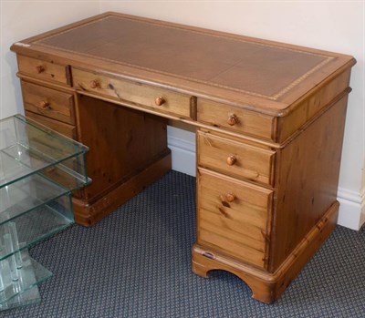 Lot 1165 - A pine kneehole desk, leather inset, 121cm by 61cm by 76cm