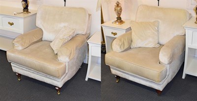 Lot 1179 - A pair of modern upholstered armchairs in cream fabric