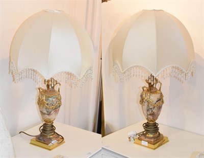 Lot 1180 - A pair of gilt metal and marble twin handle urn form table lamps, with ribbon tie and swag...