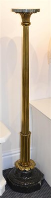 Lot 1185 - A marble and gilt metal torchere, the circular top above a reeded standard raised on an...
