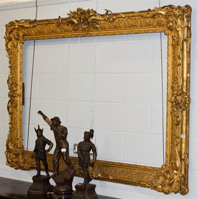 Lot 1196 - A very large 19th century gilt and gesso picture frame, ornately decorated with scrolling...