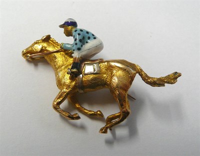 Lot 638 - A 9 Carat Gold Racehorse and Jockey Brooch, the jockey with a blue and white striped cap, and...