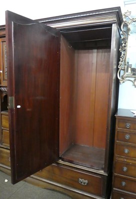Lot 1204 - A Victorian mahogany three-piece bedroom suite comprising a gentleman's carved fitted triple...