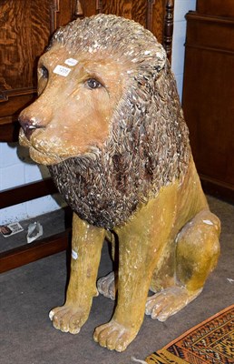 Lot 1205 - A composite painted statue of a seated lion, 72cm by 83cm high