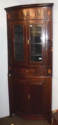 Lot 1206 - A 19th century inlaid mahogany bow-front standing corner cupboard with glazed top section and...