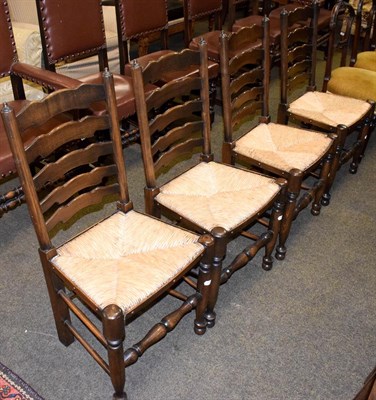 Lot 1246 - A set of four ladderback rush-seated kitchen chairs