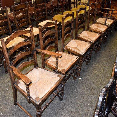Lot 1248 - A set of six oak ladderback rush-seated dining chairs, two carvers and four chairs