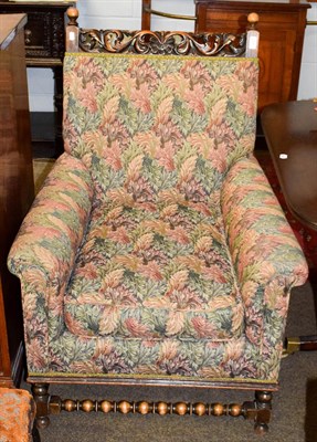 Lot 1252 - An early 20th century carved oak upholstered armchair