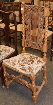 Lot 1263 - A 17th century style hall chair with carved top rail, cane back and seat