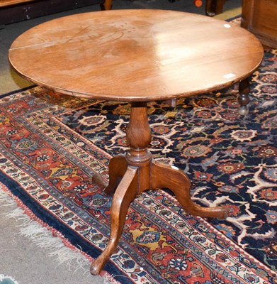 Lot 1268 - A George II oak tilt-top tripod table, 18th century and later, 85cm wide