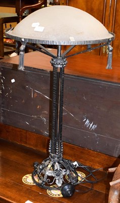Lot 1273 - An Art Nouveau style wrought iron table lamp with a frosted glass shade indistinctly signed,...