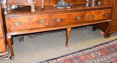 Lot 1274 - A George III oak low dresser with galleried back, three drawers and cabriole legs, 202cm by 49cm by