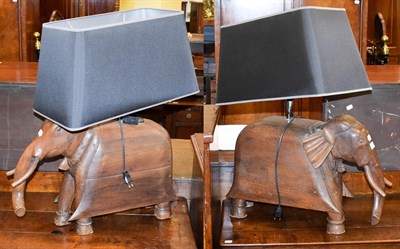 Lot 1275 - A large pair of carved oak novelty table lamps formed as stylised elephants with shades, base...