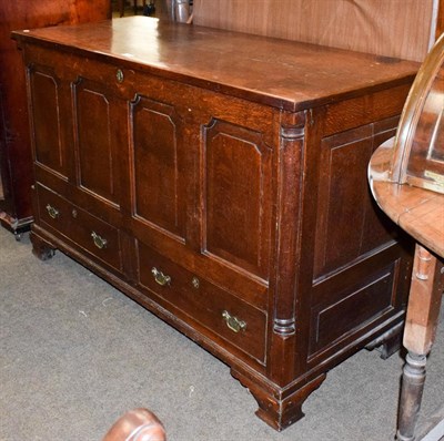 Lot 1281 - A George III oak four-panel mule chest with hinged lid and drawers below, 133cm by 53cm by 86cm